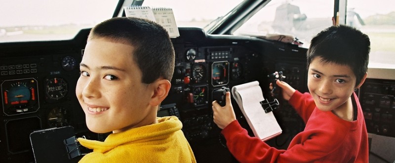 Boys in cockpit of airliner