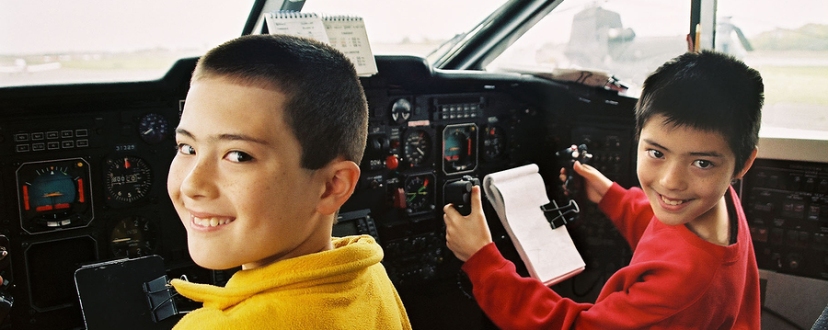 Boys in cockpit of airliner