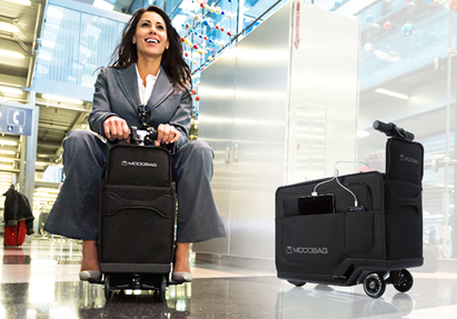 Woman on motorized, ride-able carry-on bag