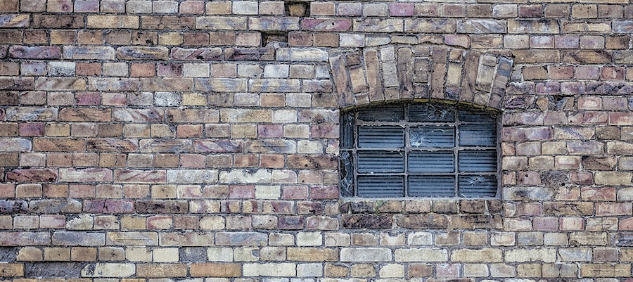 brick wall with barred window