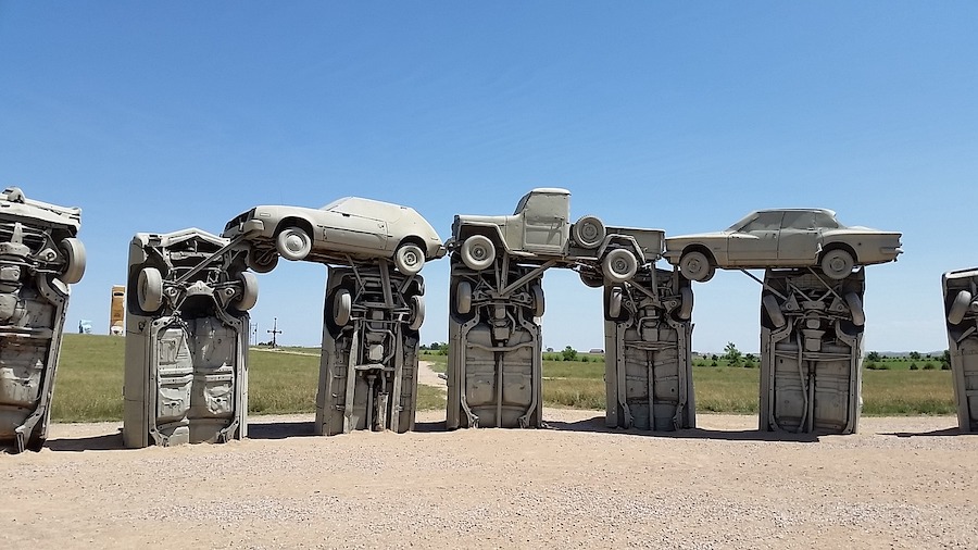 half-buried cars arranged as art